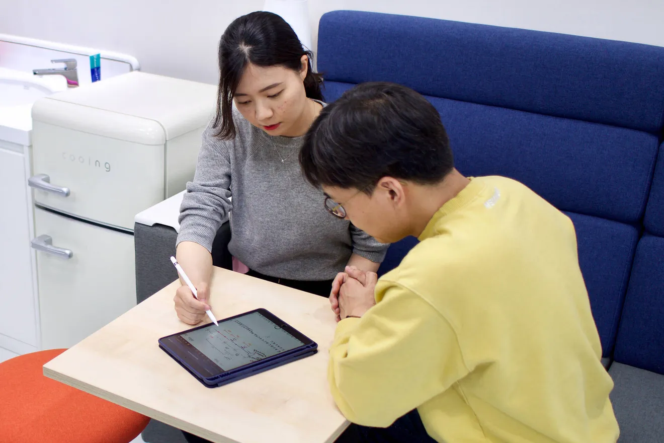 Two lab members going over data on a tablet