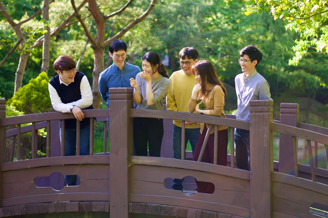 Lab members on a wooden bridge, May 2021